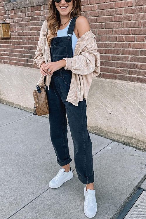 woman wearing blue corduroy overalls with a open shacket and louis vuitton bag and white sneakers